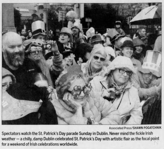 Spectators watch the St. Patrick's Day parade